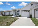 Single-story home featuring well-kept landscaping, a driveway, and a two-car garage at 4030 Casa Del Sol Way, New Port Richey, FL 34655