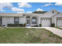 Single-story home featuring well-kept landscaping, a driveway, and a two-car garage at 4030 Casa Del Sol Way, New Port Richey, FL 34655