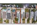 Aerial view of waterfront homes with private docks, pools, and well-manicured lawns on canal at 5106 Blue Heron Dr, New Port Richey, FL 34652