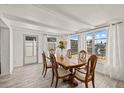 Dining room boasts an expansive window view, tile floor, and light wood dining table at 5106 Blue Heron Dr, New Port Richey, FL 34652