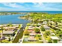 Aerial view of a waterfront property with a beautiful view of the water and neighborhood at 5404 Quist Dr, Port Richey, FL 34668