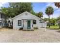 Quaint one-story home with teal door and simple landscaping at 7252 Coventry Ct, Weeki Wachee, FL 34607