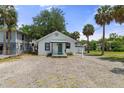 Inviting single-story home with a charming teal front door and gravel front yard at 7252 Coventry Ct, Weeki Wachee, FL 34607