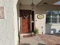 Close up of the front door, showing its welcoming design and charming exterior details at 7508 Cypress Knee Dr, Hudson, FL 34667