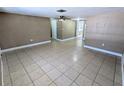 Inviting living room featuring tile floor, neutral walls, and ceiling fan at 7526 Topay Ln, Port Richey, FL 34668