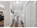 View of the hallway featuring wood floors and white closet doors at 7837 Hardwick Dr # 314, New Port Richey, FL 34653
