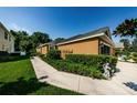 View of the side of the house with lush green landscaping and manicured bushes at 8604 Corinthian Way, New Port Richey, FL 34654