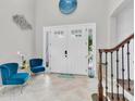 Bright foyer with high ceilings, tile flooring, and stylish decor, perfect for a warm welcome at 8945 Bella Vita Cir, Land O Lakes, FL 34637