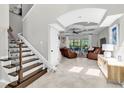 Elegant living room with tile flooring, staircase and lots of natural light, offering a welcoming atmosphere at 8945 Bella Vita Cir, Land O Lakes, FL 34637