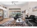 Cozy living room featuring comfortable seating, natural light, and sliding glass doors at 9208 Butler Blvd, Weeki Wachee, FL 34613