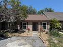 Charming single story home featuring a covered entry and meticulously maintained landscaping at 947 Village Dr, Brooksville, FL 34601