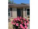Inviting home exterior with potted plants flanking the front door, adding a touch of charm at 947 Village Dr, Brooksville, FL 34601