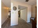Hallway showing durable wood flooring and neutral walls, creating a seamless transition at 947 Village Dr, Brooksville, FL 34601