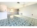 Bright living room with tile flooring, ceiling fan, and plenty of natural light at 9850 Richwood Ln, Port Richey, FL 34668