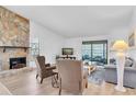 Inviting living room with stone fireplace, comfortable seating, and sliding glass doors to the outdoors at 9970 Eagles Point Cir # 3, Port Richey, FL 34668