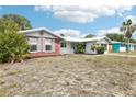 Charming single-story home featuring brick accents and a well-maintained lawn, offering classic curb appeal at 10309 Honeysuckle Ln, Port Richey, FL 34668