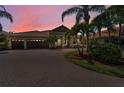 Charming home with a three car garage, brick paved driveway, and lush tropical landscaping at 1033 Tuscany Dr, Trinity, FL 34655