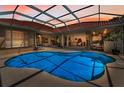 Beautiful backyard pool featuring an outdoor enclosure and seamless flow to the home's interior at 1033 Tuscany Dr, Trinity, FL 34655