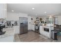 Open-concept kitchen with granite countertops, stainless steel appliances, and seamless flow into the living area at 12708 River Mill Dr, Hudson, FL 34667
