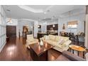 Spacious open-concept living area with hardwood floors, coffered ceilings, and seamless flow to the kitchen and dining at 12800 Solola Way, Trinity, FL 34655