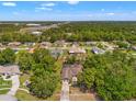 Aerial view of a residential neighborhood featuring well-maintained homes with mature trees and green spaces at 13469 Pia Ct, Spring Hill, FL 34609