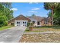 Well-maintained one-story home featuring a brick and siding exterior, two-car garage, and a neatly landscaped front yard at 13469 Pia Ct, Spring Hill, FL 34609