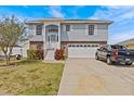 Charming two-story home with a well-maintained lawn, two-car garage, and inviting entryway at 15535 Allmand Dr, Hudson, FL 34667