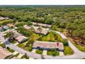 Birds eye view of the home nestled within a lush, green neighborhood setting at 18441 Whitacre Cir, Hudson, FL 34667