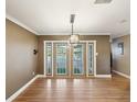 Dining room featuring french doors, hardwood floors, and modern lighting at 196 Lark Ave, Brooksville, FL 34601