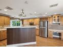 Spacious kitchen with wooden cabinetry, stainless steel appliances, and ample counter space at 196 Lark Ave, Brooksville, FL 34601