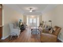 Open living room with vaulted ceilings, neutral colors, hardwood floors and lots of natural light at 2235 Lytham Ct, Spring Hill, FL 34606