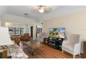 Comfortable living room with wood floors, neutral colors and plenty of natural light at 2235 Lytham Ct, Spring Hill, FL 34606