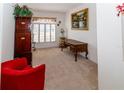 Inviting living room with plush carpeting, plantation shutters, and stylish, vintage furnishings at 2325 Pleasant Hill Ln, Holiday, FL 34691