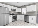 The kitchen features new appliances, ample white cabinets, and granite countertops for a modern cooking space at 27198 Simona Ave, Brooksville, FL 34602