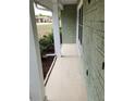 Covered porch area with painted white columns and an exterior with painted block at 273 Gulfport Ln, Spring Hill, FL 34608