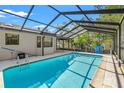 Inviting screened-in pool area with comfortable seating, perfect for relaxation and entertainment at 3029 Harrow Rd, Spring Hill, FL 34606