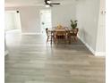 Inviting dining area features modern flooring, a wooden table with chairs, and ample natural light at 3545 Oxford Dr, Holiday, FL 34691