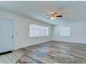 Bright living room featuring two windows and wood floors with a ceiling fan at 37733 14Th Ave, Zephyrhills, FL 33542