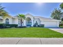 Inviting one-story home with a well-kept lawn and double door entrance at 4044 Chesterfield Dr, Spring Hill, FL 34609