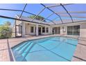 Relaxing screened-in pool area with brick pavers and a covered lanai at 4044 Chesterfield Dr, Spring Hill, FL 34609