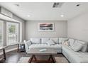 Bright living room features a plush sectional sofa, bay window, and modern decor at 4315 Oakland Dr, New Port Richey, FL 34653