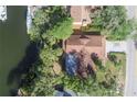 Birds eye view shows the roof, driveway and dock on the canal behind the property at 4328 Marine Pkwy, New Port Richey, FL 34652