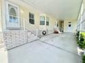 Spacious covered carport featuring painted concrete and white brick style decor around the base at 585 Sky Harbor Dr # 219, Clearwater, FL 33759