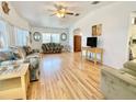 Inviting living room with hardwood floors, vaulted ceiling, and bright natural light at 585 Sky Harbor Dr # 219, Clearwater, FL 33759