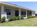 The rear of the house has a covered patio with columns and a well-maintained green lawn at 6063 Dusk Rose Ln, Brooksville, FL 34601