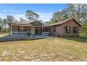 Inviting single-story home with a cozy front porch and well-maintained front yard at 6080 Dexter Ln, Brooksville, FL 34602