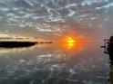 Beautiful sunset view reflecting on calm water at 6622 Seaview Blvd, Hudson, FL 34667