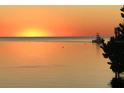 Gorgeous sunset view on the water with a boat sailing by at 6622 Seaview Blvd, Hudson, FL 34667