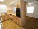 The open kitchen with breakfast bar and a view into the carpeted living area at 6636 Timbercove Ln # 6636, New Port Richey, FL 34653