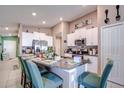 Open kitchen with a breakfast bar, granite countertops, stainless steel appliances, and a view of the adjacent living space at 680 Argyll Dr, Spring Hill, FL 34609